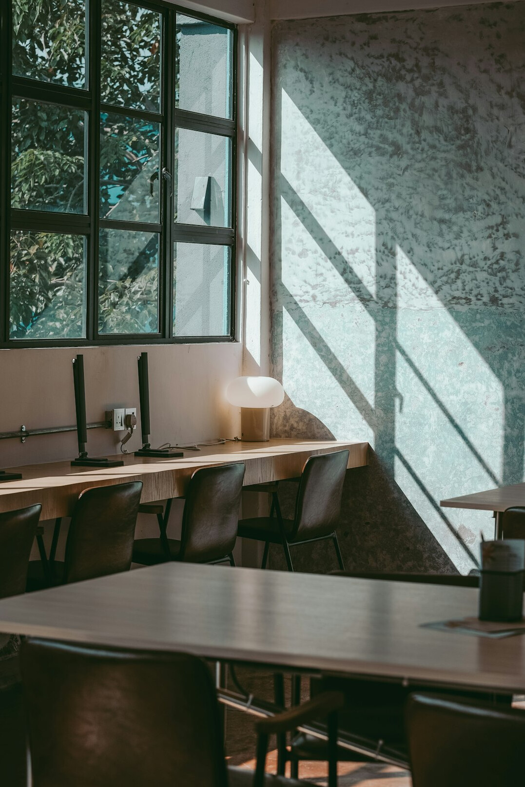 Modern open plan office with desks and large windows