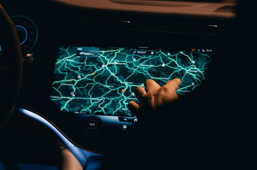 Person's hand pointing at a data dashboard on a tablet screen